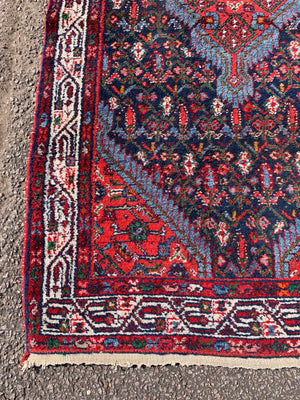 A large blue lozenge Persian rug - 181cm x 105cm