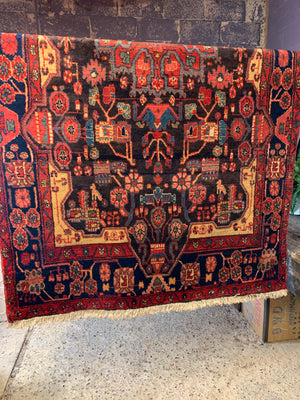 A very large rectangular red ground Persian rug