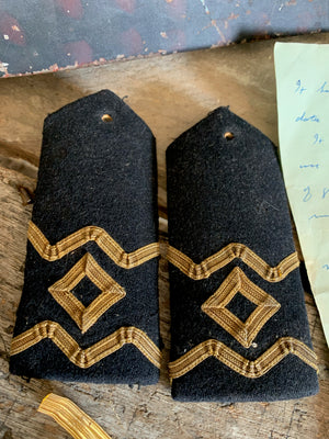 A naval bicorn hat, tin, epaulettes and other insignia