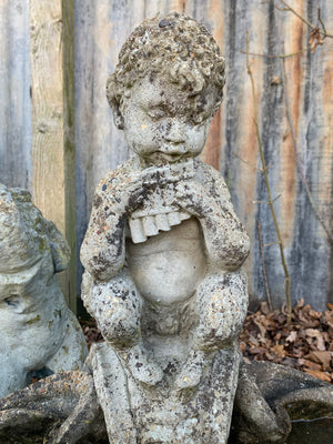 A cast stone bird bath with the figure of a fawn