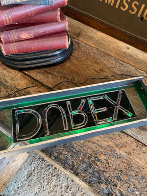 An illuminated Durex sign