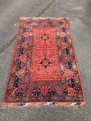 A hand woven Persian orange ground rectangular rug