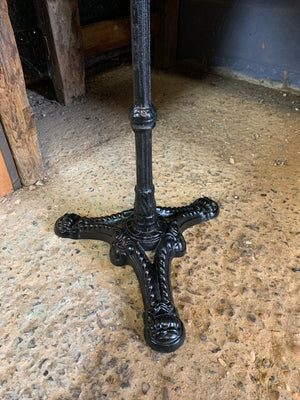 A black cast iron bistro table with marble top 2/3