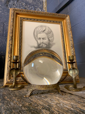 A fortune teller's crystal ball on a silver plated Art Nouveau stand