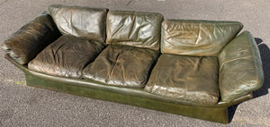 A large 3 seater Modernist Italian sofa in green leather of boat or 'egg' form