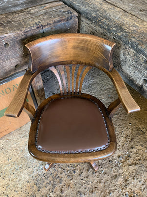 An oak rotating banker's desk chair