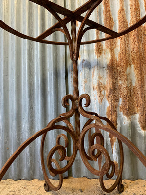 A cast iron garden table with marble top