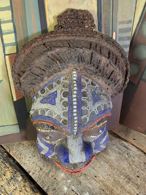 A carved wood African Bamum mask from Cameroon