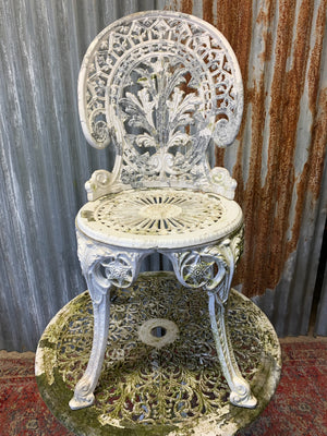 A white cast metal garden set - a table and two chairs