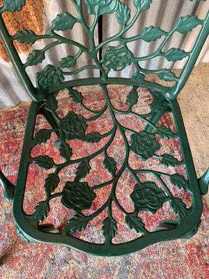 A green Victorian style table and two chairs set