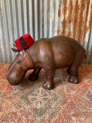 A large brown leather Liberty & Co. hippo footstool