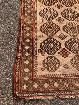 A large rectangular brown ground Persian rug