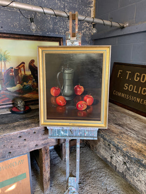 A large still life oil painting of apples and a tankard