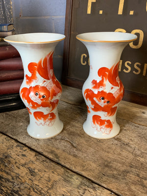 A pair of Chinese ceramic foo dog vases