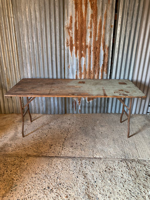 A wooden plank top folding trestle table - Table 1