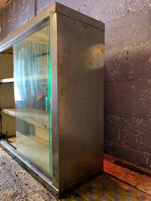 A vintage industrial stripped steel medical cabinet