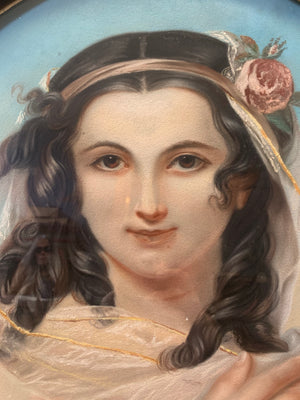 An early 19th Century chalk portrait of a lady in an ornate oval frame