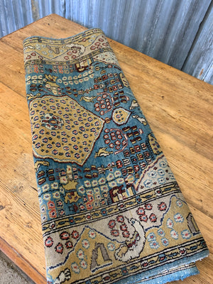 A hand woven Persian blue and yellow ground rectangular rug
