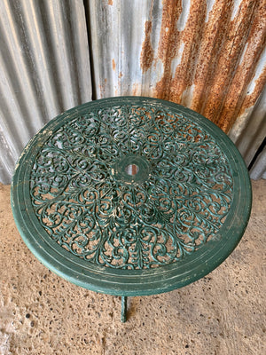 A green garden table and chairs set