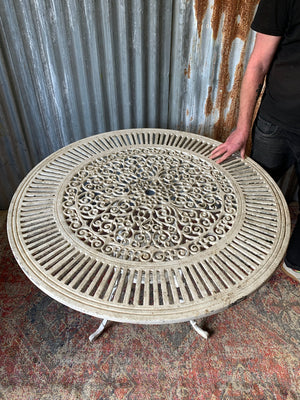 A white cast metal garden set - a large table and two chairs