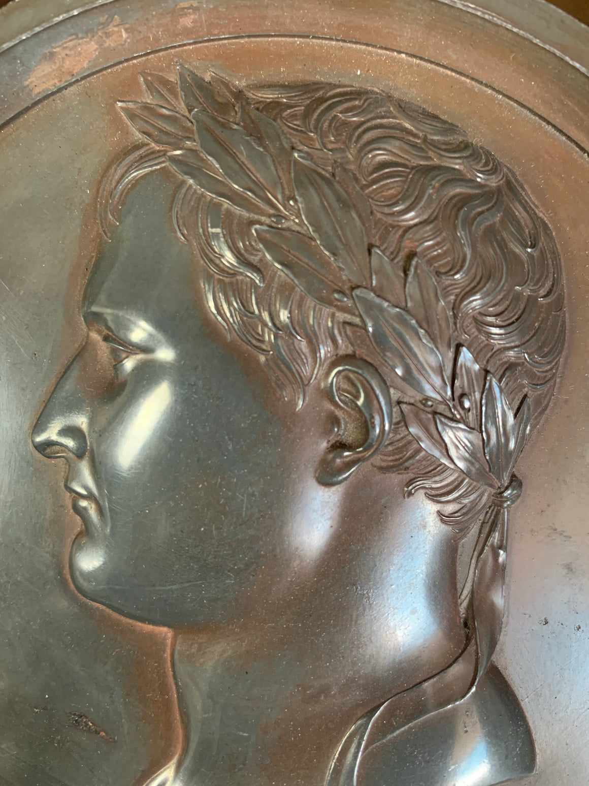 A framed "bronzed" lead medallion of Napoleon