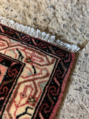 A long pink and red ground Persian Hosseinabad runner rug