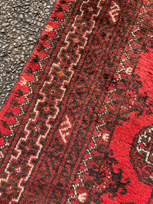 A red ground Bokhara rectangular rug- 180cm x 100cm
