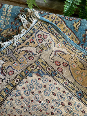 A hand woven Persian blue and yellow ground rectangular rug