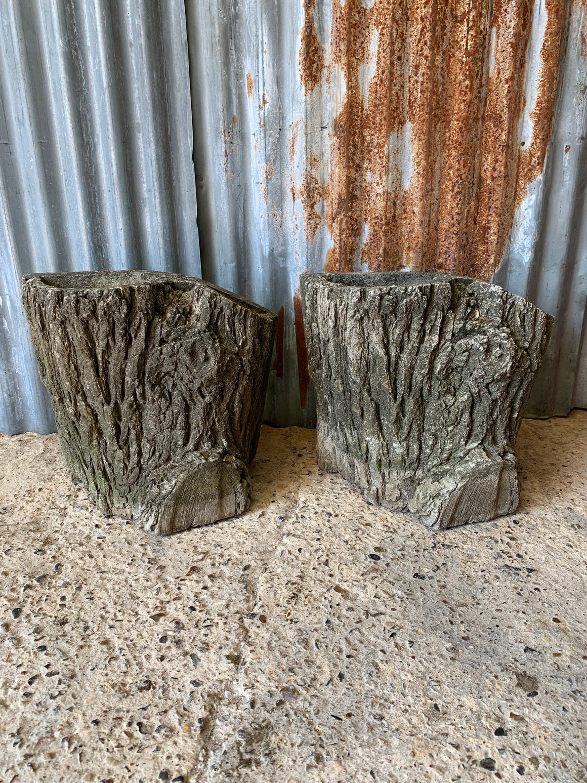A pair of cast stone faux bois planters