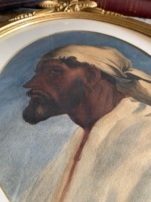 A watercolour portrait of a man in an oval gilt frame