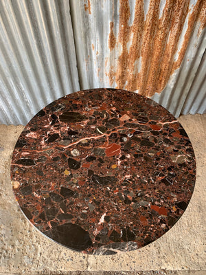 A black cast iron bistro table with red Palladio granite top - large (one available)