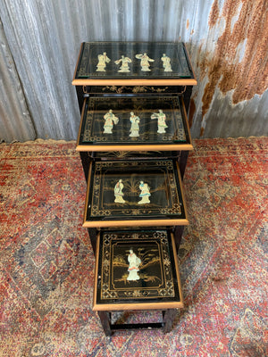 A nest of four black lacquered Chinoiserie tables