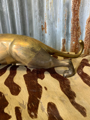 A brass prowling leopard statue