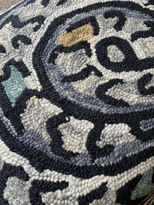 A woollen coiled serpent rug