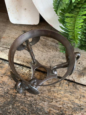 A large fortune teller's crystal ball on a bronze stand