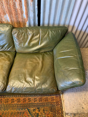 A large 3 seater Modernist Italian sofa in green leather of boat or 'egg' form