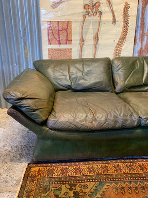 A large 3 seater Modernist Italian sofa in green leather of boat or 'egg' form